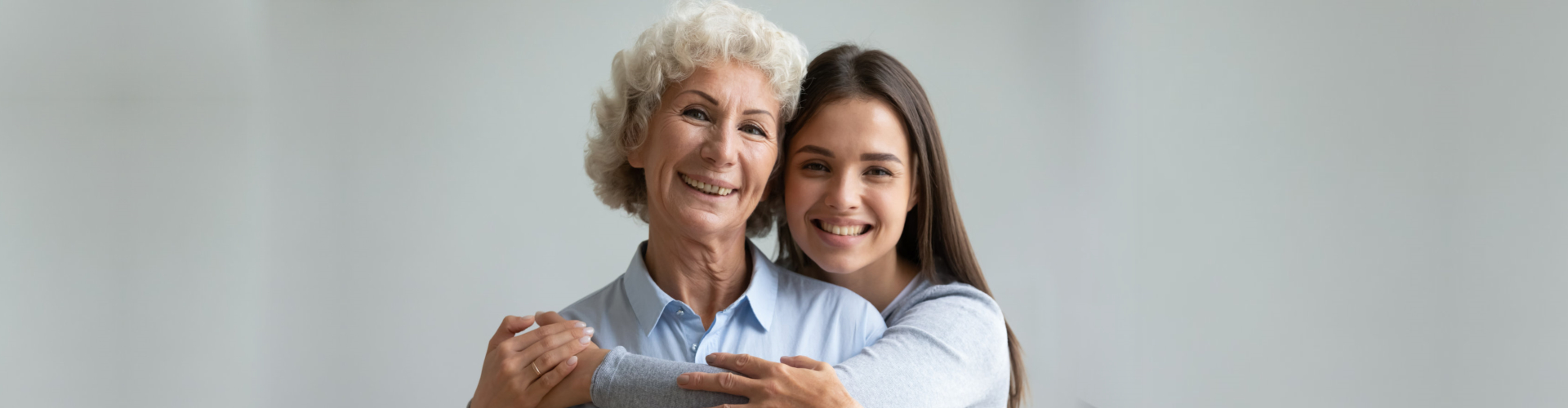 caregiver and senior woman smiling